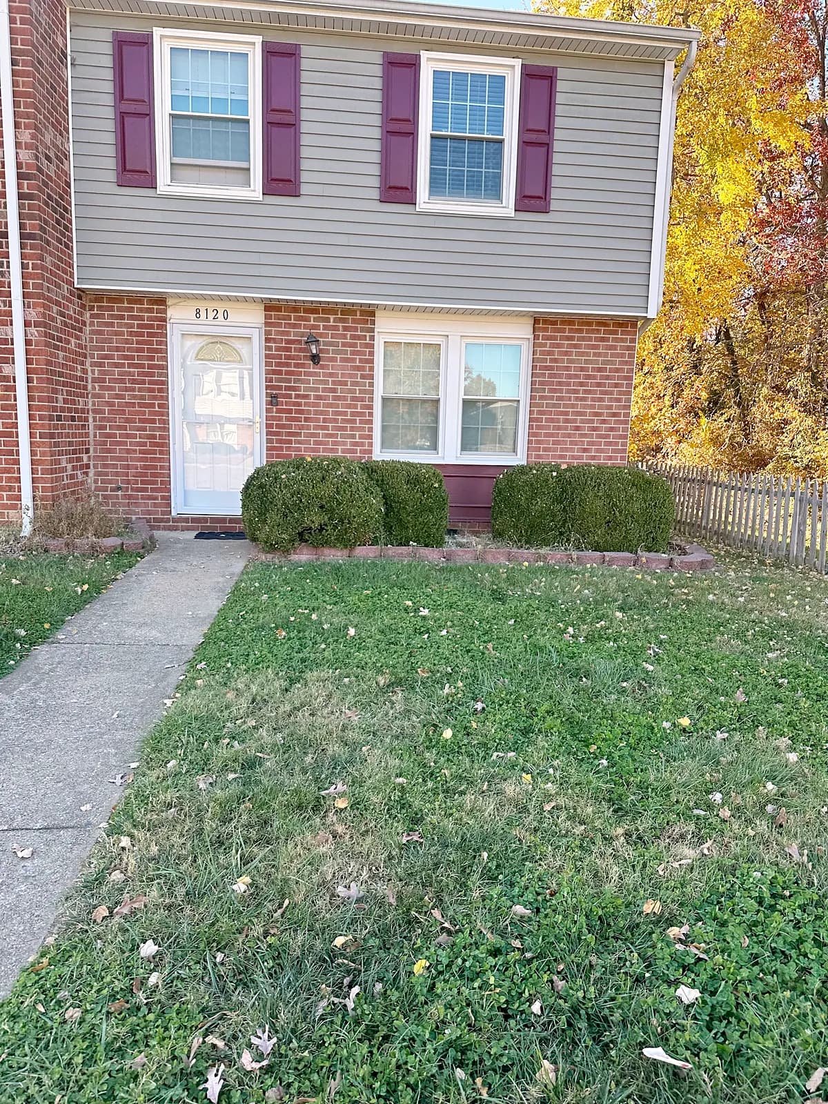 Front of the Beyon Vital home, a two-story brick and siding home with house number 8120 above the door